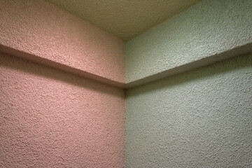 Aufkleber - Textured wall corner with pastel pink and green colors, soft lighting, and quiet atmosphere, showing where light collects dust in minimalist interior