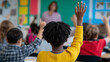 © Curioso.Photography - School children raising hands during class with a teacher in front of the blackboard.