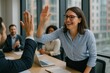 © Thitiporn - High Five in Business : A joyful high five moment between two business colleagues in a vibrant office setting, symbolizing achievement and camaraderie.
