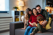 © NDABCREATIVITY - Happy family with pregnant mother and cute children have a fun at home and hug each other