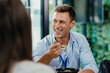 © Suteren Studio - Young businessman eating healthy salad lunch with colleagues in modern office cafeteria
