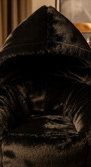 Poster - Dark brown plush fur texture with a hooded design, creating a cozy and warm visual, showcasing softness and comfort, ideal for relaxation or luxury product displays