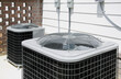 © Tetra Images - Residential air conditioning units outside building