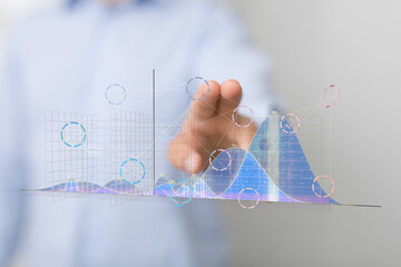 Poster - Stock photo of a businessman interacting with digital charts and graphs, visualizing data analysis and business insights.