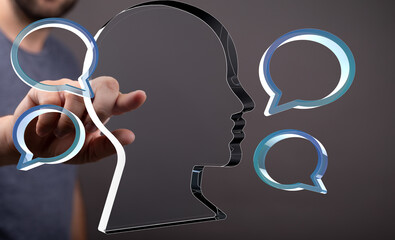 Leinwandbilder - Concept image: Man interacts with digital head and speech bubbles, symbolizing communication and ideas.