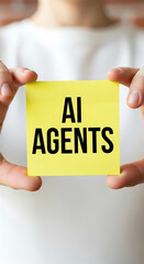 Poster - Someone holding a yellow sticky note with the text ai agents in black font