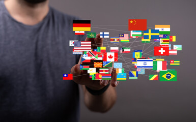 Poster - A man interacts with a digital network of world flags, symbolizing global connections and international collaboration.