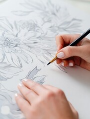 Poster - Artist delicately illustrating floral designs on paper with a fine pen in a serene workspace