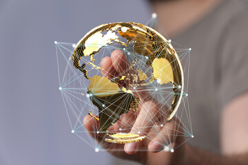 Poster - Hand interacting with a 3D golden globe, representing global network and connections.