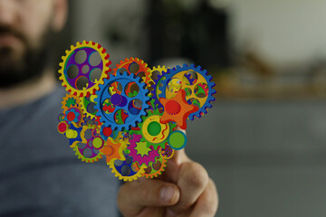 Poster - Abstract image of colorful gears representing teamwork, innovation, and complex systems.