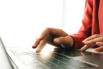 Wall Mural - close-up portrait typing keyboard on laptop computer. working online on white table at office. faceb