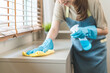 © KMPZZZ - Cleanliness, asian young woman work chore cleaning on cupboard at home, hand wearing glove using wiping cloth remove dust with spray bottle. Household hygiene clean up, equipment tool for cleaning