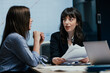© Suteren Studio - Young female colleague receives mentorship at a meeting in office