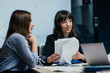 © Suteren Studio - Female colleagues listening attentively to opinion during business meeting in office