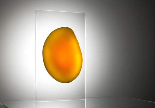 Abstract Golden Blob Inside Transparent Glass Panel | Modern Minimalist Design Element for Technology and Innovation Concepts