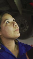 Poster - Animation of light over female car mechanic checking car