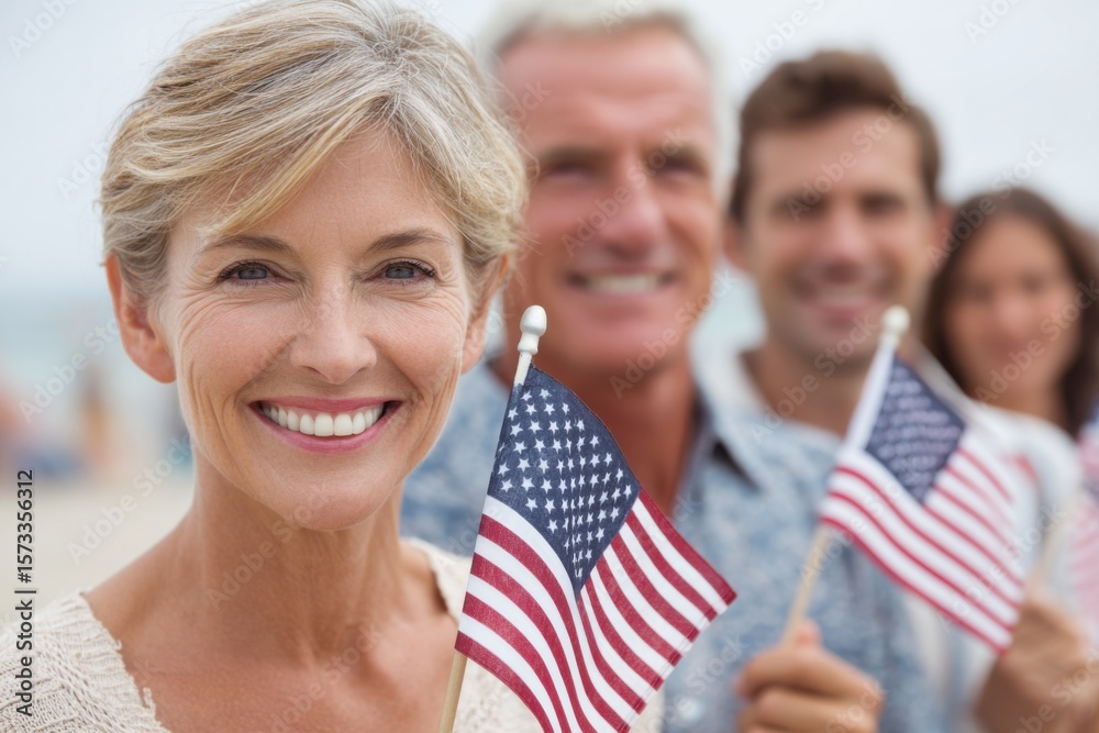 Smiling woman holding small American flag stands in front of friends ...