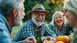 © Shannon - A group of retired friends laughing together at an outdoor picnic