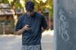 © carballo - young man or teenager using smartphone on the street
