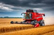 © Lubos Chlubny - Red combine harvester harvesting wheat field under stormy sky