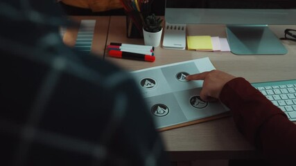 Poster - A person is actively using a computer at a desk filled with colorful stationery and documents, highlighting a creative and organized workspace in a modern office. SACTR