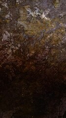 Wall Mural - Vertical Crumbling Grunge Wall Debris Background 4K Loop features an old crumbling wall with debris falling and dust swirling in a vertical ratio loop.