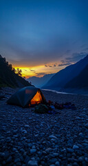Wall Mural - A camping tent has been set up on the hillside, with a warm orange light glowing softly from within, illuminating the surrounding camping equipment laid out in front.