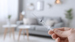 © Benjamin - A Safe At Home Medical Injection concept portrayed by a hand holding a sterile syringe in a bright living room.