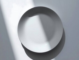 Poster - Minimalist pristine white ceramic plate casting a dramatic shadow effect