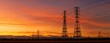 © Albi - The towering electricity pylons silhouetted against a vibrant sunset sky.