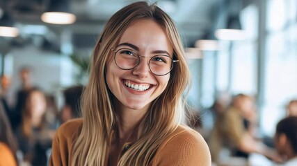 Poster - A woman with glasses is smiling and looking at the camera. She is surrounded by a group of people, some of whom are also smiling. Scene is happy and friendly