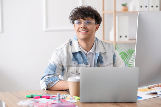 Male graphic designer working at table in office