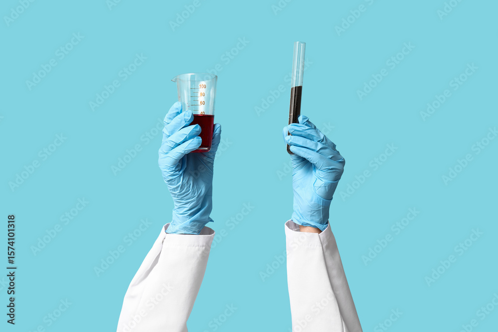 Scientist's hands holding test tubes with soil and red liquid on blue ...