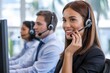 © GraphixStudio - Smiling customer service agent wearing a headset helps customers