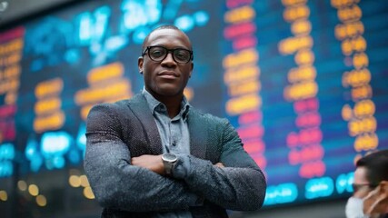 Poster - Financial Analyst: A confident, professional stands before a vibrant stock ticker, embodying the dynamic world of finance and strategic investment.