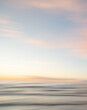 © Virsis - A dreamy, impressionistic paint like blurred sea sunset background with gently soft pastel colours. Vertical photo.