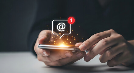 Poster - Hands hold phone, displaying email notification with glowing particles.  Illustrates digital communication and new message alert