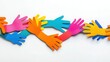 © Bushra - Colorful Paper Hands Holding Each Other Symbolizing Unity and Diversity on White Background.