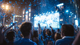 A large crowd of soccer fans wearing blue shirts cheering and watching a live game on a big outdoor screen during a sports event celebration.