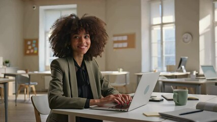 Poster - Woman focused on typing at laptop, enjoying a productive moment in a bright and airy workspace. Modern office design with wooden furniture and greenery. Concept of remote work, productivity, business