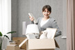 © New Africa - Moving day. Happy woman with her belongings in new home