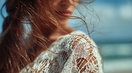 soft-focus shot of lace beach cover-up blowing in wind