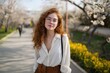 © Andrii Zastrozhnov - Caucasian young female enjoying spring in a park with blossoming trees