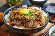 © nsit0108 - Steaming japanese gyudon beef bowl with rice and a raw egg yolk, garnished with chopped green onions and fried onions