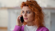© Yuliia - Close anxiety worried sad serious frustrated upset Caucasian woman lady girl indoor at home female talking mobile phone smartphone conversation listening bad news cellphone call problem trouble stress