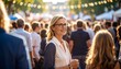 © Aw - Smiling woman at a crowded outdoor festival