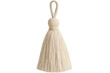 © Michael - Neutral-toned yarn tassel suspended against translucent backdrop, complementing handcraft designs with organic texture
