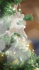 Wall Mural - christmas decorations with reindeer ornament over bokeh lights animation on tree