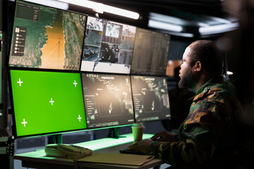 Poster - Army telecommunication systems agent using radio and satellite tech, providing combat support, watching mockup screens. Soldier managing communications networks, looking at chroma key monitors