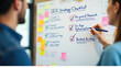© MRSJAHANARA - Two people collaborating on a whiteboard planning an seo strategy checklist with sticky notes